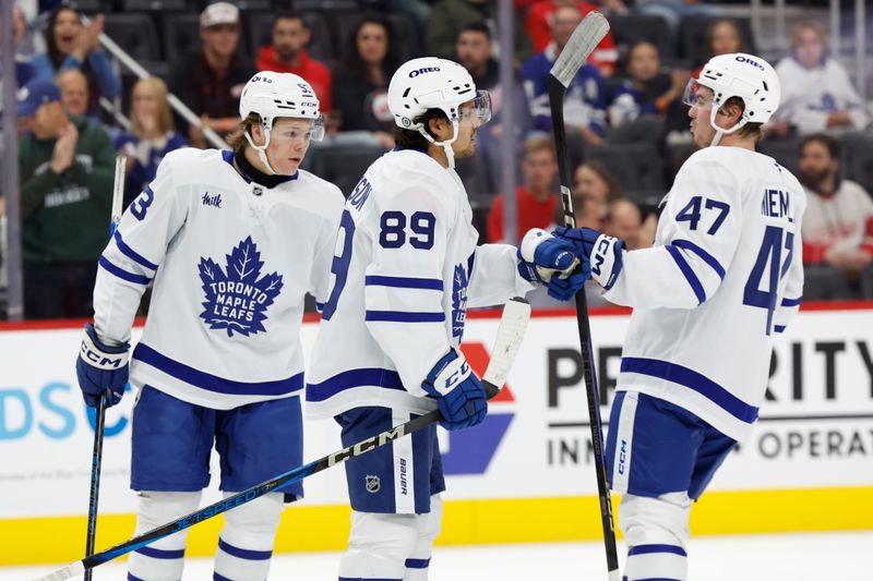 Oct 3, 2024; Detroit, Michigan, USA;  Toronto Maple Leafs left wing Nicholas Robertson (89) receives congratulations from teammates after scoring in the first period against the Detroit Red Wings at Little Caesars Arena. Mandatory Credit: Rick Osentoski-Imagn Images