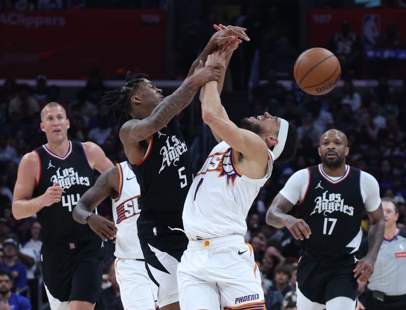 LOS ANGELES, CALIFORNIA - APRIL 10: Devin Booker #1 of the Phoenix Suns reacts as he is fouled by Bones Hyland #5 of the LA Clippers during a 124-108 Suns win at Crypto.com Arena on April 10, 2024 in Los Angeles, California. User is consenting to the terms and conditions of the Getty Images License Agreement.  (Photo by Harry How/Getty Images)