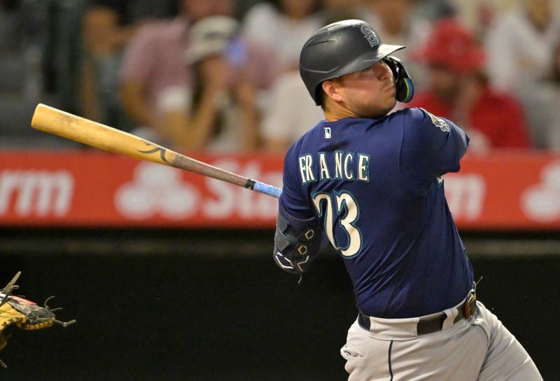 Aug 5, 2023; Anaheim, California, USA; Seattle Mariners first baseman Ty France (23) hits a RBI single in the eighth inning against the Los Angeles Angels at Angel Stadium. Mandatory Credit: Jayne Kamin-Oncea-USA TODAY Sports