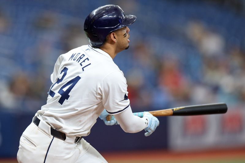 Sep 5, 2024; St. Petersburg, Florida, USA; Tampa Bay Rays second baseman Christopher Morel (24) triples against the Minnesota Twins in the eighth inning at Tropicana Field. Mandatory Credit: Nathan Ray Seebeck-Imagn Images