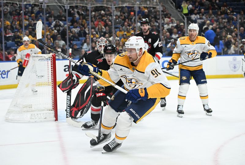 Jan 31, 2025; Buffalo, New York, USA; Nashville Predators center Steven Stamkos (91) chases the puck in front of Buffalo Sabres left wing Beck Malenstyn (29) in the first period at the KeyBank Center. Mandatory Credit: Mark Konezny-Imagn Images