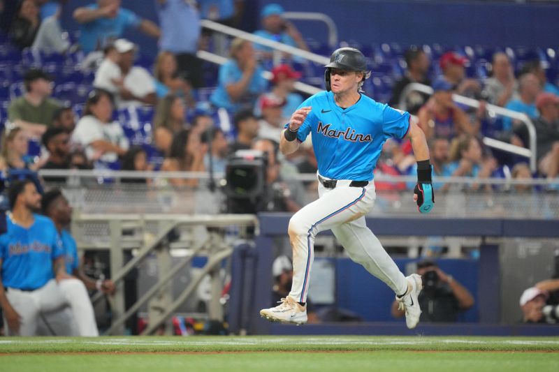 Aug 25, 2024; Miami, Florida, USA;  Miami Marlins left fielder Kyle Stowers (28) scores a run against the Chicago Cubs in the eighth inning at loanDepot Park. Mandatory Credit: Jim Rassol-USA TODAY Sports