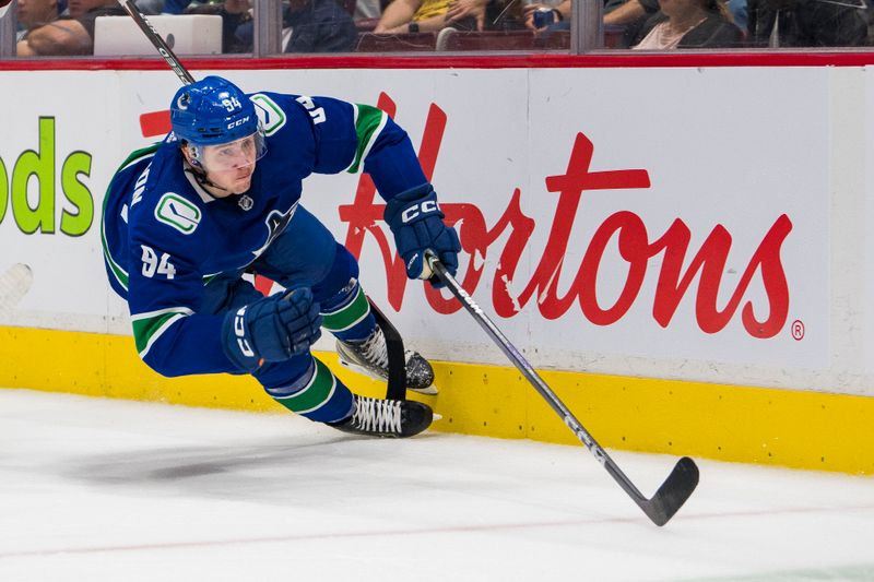 Oct 7, 2022; Vancouver, British Columbia, CAN; Vancouver Canucks forward Linus Karlsson (94) gets tripped up against the Arizona Coyotes in the second period at Rogers Arena. Mandatory Credit: Bob Frid-USA TODAY Sports