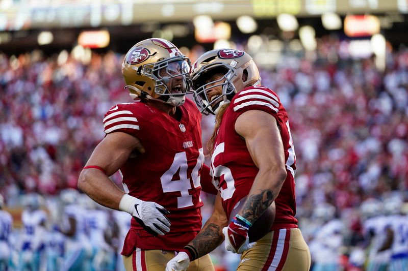 San Francisco 49ers tight end George Kittle, right, celebrates with fullback Kyle Juszczyk after scoring a touchdown against the Dallas Cowboys during the first half of an NFL football game Sunday, Oct. 8, 2023, in Santa Clara, Calif. (AP Photo/Godofredo A. Vásquez)