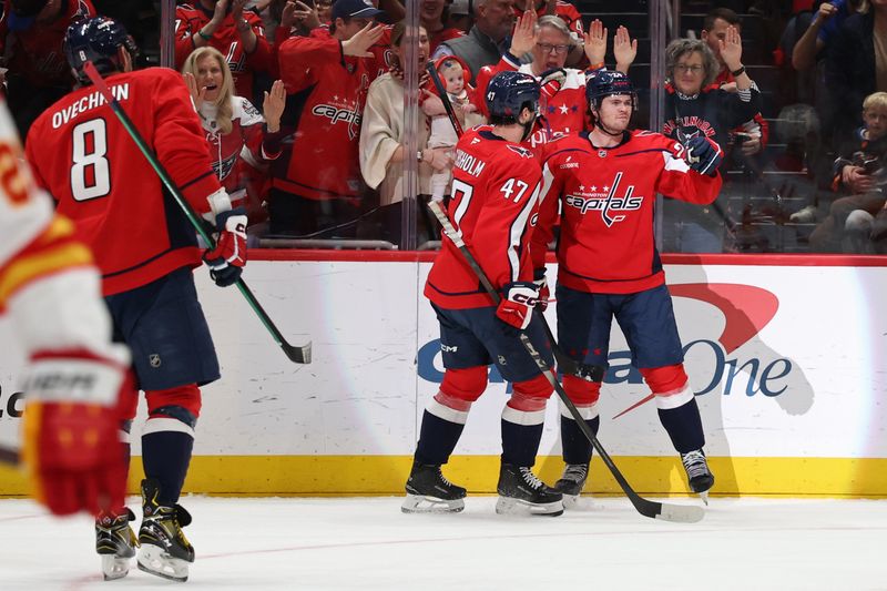 Mar 9, 2026; Washington, District of Columbia, USA; Washington Capitals left wing Connor McMichael (24) celebrates with teammates after scoring a goal against the Calgary Flames during the first period at Capital One Arena. Mandatory Credit: Geoff Burke-Imagn Images
