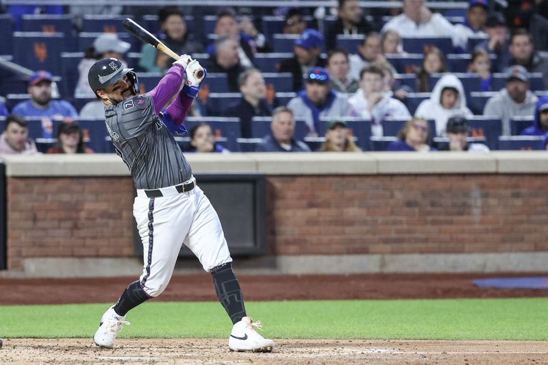 May 24, 2025; New York City, New York, USA;  New York Mets catcher Luis Torrens (13) hits a single in the fourth inning against the Los Angeles Dodgers at Citi Field. Mandatory Credit: Wendell Cruz-Imagn Images