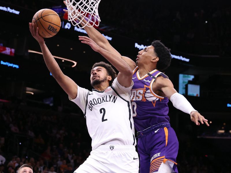 PHOENIX, ARIZONA - NOVEMBER 27: Cameron Johnson #2 of the Brooklyn Nets attempts a layup against Ryan Dunn #0 of the Phoenix Suns during the first half at Footprint Center on November 27, 2024 in Phoenix, Arizona. NOTE TO USER: User expressly acknowledges and agrees that, by downloading and or using this photograph, User is consenting to the terms and conditions of the Getty Images License Agreement.  (Photo by Chris Coduto/Getty Images)