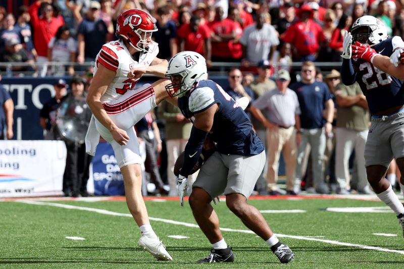 Nov 18, 2023; Tucson, Arizona, USA; Arizona Wildcats linebacker Anthony Ward (57) blocks a punt by Utah Utes punter Jack Bouwmeester (34) during the first half at Arizona Stadium. Mandatory Credit: Zachary BonDurant-USA TODAY Sports