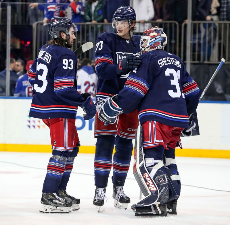 Mar 9, 2024; New York, New York, USA; New York Rangers center Matt Rempe (73) and center Mika Zibanejad (93) celebrate a 4-0 win against the St. Louis Blues with goalie Igor Shesterkin (31) at Madison Square Garden. Mandatory Credit: Danny Wild-USA TODAY Sports