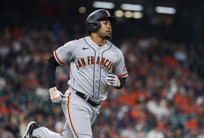 May 1, 2023; Houston, Texas, USA; San Francisco Giants first baseman LaMonte Wade Jr. (31) runs to first base on a single during the first inning against the Houston Astros at Minute Maid Park. Mandatory Credit: Troy Taormina-USA TODAY Sports