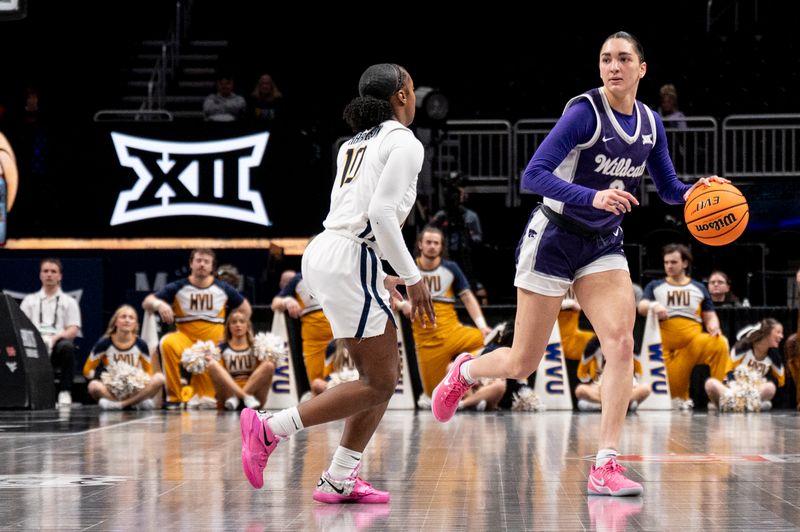 Mar 7, 2025; Kansas City, MO, USA; Kansas State Wildcats guard Brylee Glenn (5) handles the ball while defended by West Virginia Mountaineers guard Jordan Harrison (10) in the third quarter at T-Mobile Center. Mandatory Credit: Amy Kontras-Imagn Images