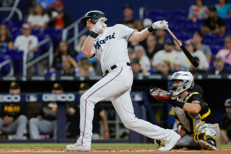 Jun 25, 2023; Miami, Florida, USA; Miami Marlins designated hitter Garrett Cooper (26) hits a single against the Pittsburgh Pirates during the first inning at loanDepot Park. Mandatory Credit: Sam Navarro-USA TODAY Sports