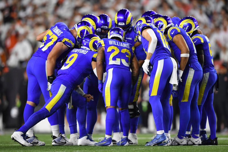 Los Angeles Rams quarterback Matthew Stafford (9) huddles with teammates during an NFL football game against the Cincinnati Bengals on Monday, Sept. 25, 2023, in Cincinnati. (AP Photo/Emilee Chinn)