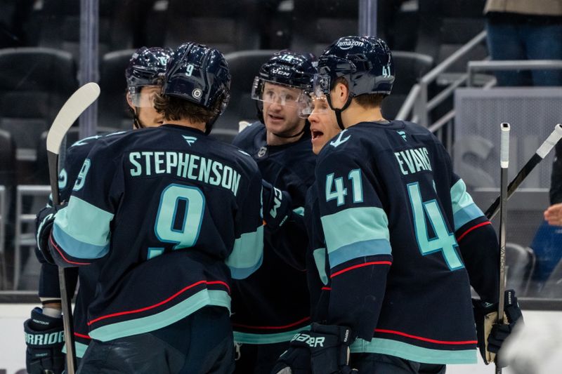 Nov 14, 2024; Seattle, Washington, USA;  Seattle Kraken including, from left, defenseman Brandon Montour (62), forward Chandler Stephenson (9) , forward Jared McCann (19), forward Jaden Schwartz (17) and defenseman Ryker Evans (41) celebrate a goal during the third period against the Chicago Blackhawks at Climate Pledge Arena. Mandatory Credit: Stephen Brashear-Imagn Images