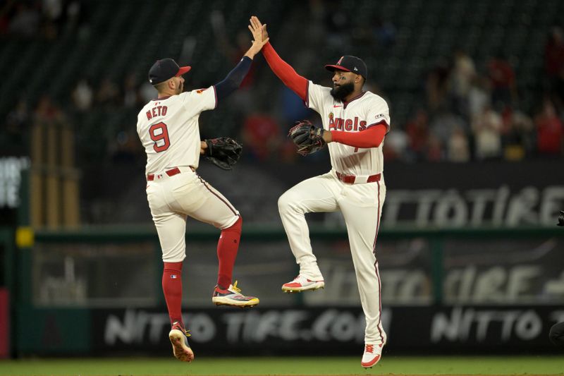 Jul 30, 2024; Anaheim, California, USA; Los Angeles Angels shortstop Zach Neto (9) and right fielder Jo Adell (7) high five after the final out of the ninth inning against the Colorado Rockies at Angel Stadium. Mandatory Credit: Jayne Kamin-Oncea-USA TODAY Sports