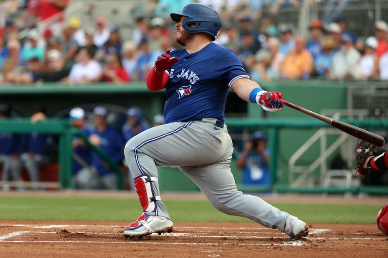 Mar 3, 2024; Fort Myers, Florida, USA; Toronto Blue Jays catcher Alejandro Kirk (30) singles during the first inning against the Boston Red Sox at JetBlue Park at Fenway South. Mandatory Credit: Kim Klement Neitzel-USA TODAY Sports