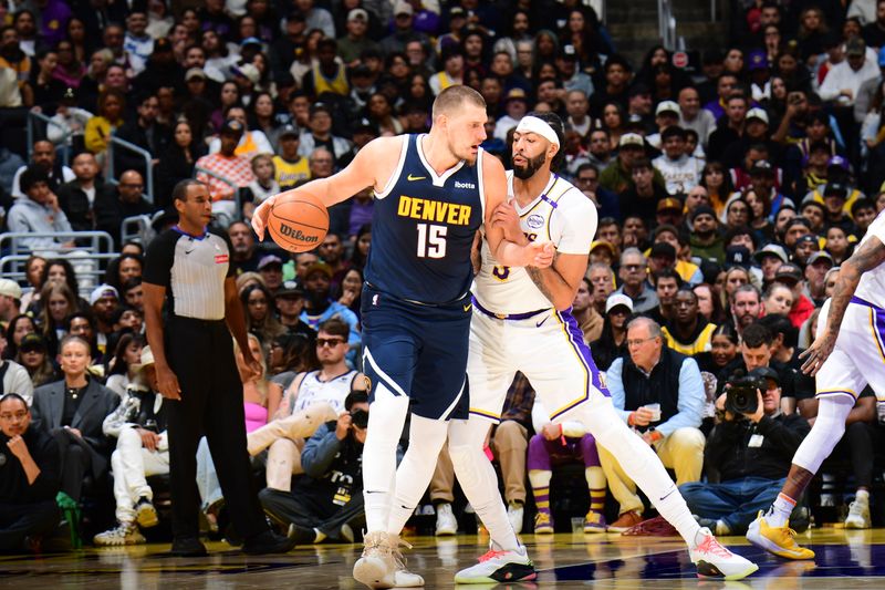 LOS ANGELES, CA - NOVEMBER 23: Nikola Jokic #15 of the Denver Nuggets dribbles the ball during the game against the Los Angeles Lakers on November 23, 2024 at Crypto.Com Arena in Los Angeles, California. NOTE TO USER: User expressly acknowledges and agrees that, by downloading and/or using this Photograph, user is consenting to the terms and conditions of the Getty Images License Agreement. Mandatory Copyright Notice: Copyright 2024 NBAE (Photo by Adam Pantozzi/NBAE via Getty Images)