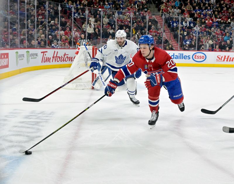 Mar 9, 2024; Montreal, Quebec, CAN; Montreal Canadiens forward Juraj Slafkovsky (20) plays the puck and Toronto Maple Leafs defenseman Joel Edmundson (20) defends during the second period at the Bell Centre. Mandatory Credit: Eric Bolte-USA TODAY Sports