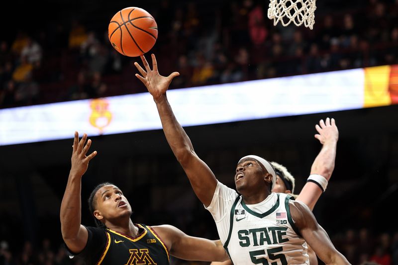 Dec 4, 2024; Minneapolis, Minnesota, USA; Michigan State Spartans forward Coen Carr (55) and Minnesota Golden Gophers forward Frank Mitchell (00) jump for the ball during the second half at Williams Arena. Mandatory Credit: Matt Krohn-Imagn Images