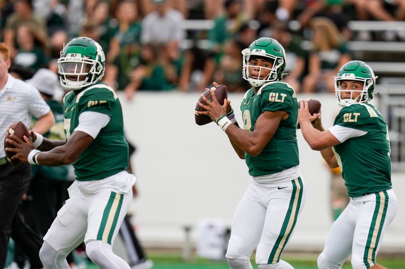 Sep 10, 2022; Charlotte, North Carolina, USA; Charlotte 49ers quarterback James Foster (7), quarterback Xavier Williams (8) and quarterback Chris Reynolds (3) show during pregame activity against the Maryland Terrapins at Jerry Richardson Stadium. Mandatory Credit: Jim Dedmon-USA TODAY Sports