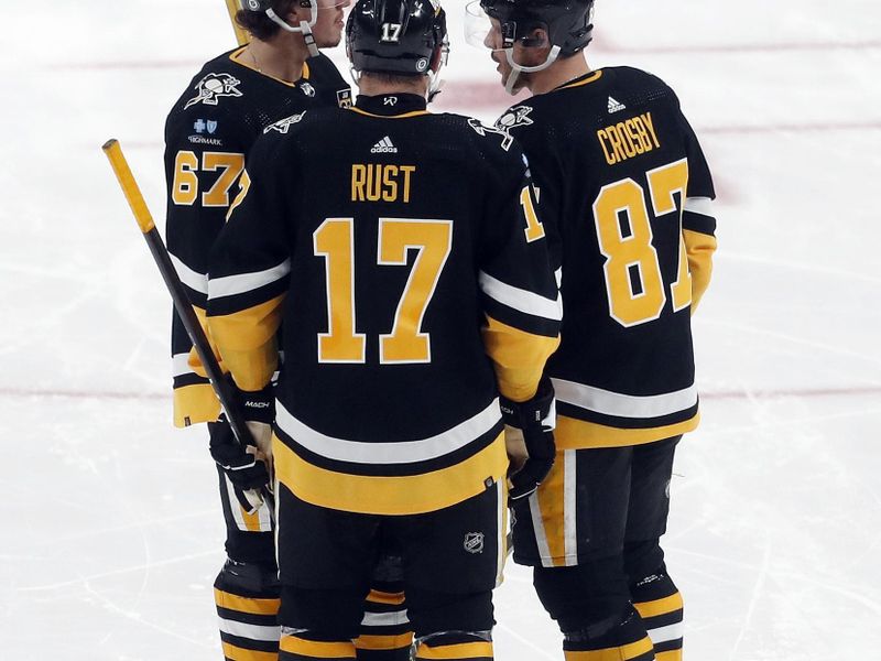 Feb 18, 2024; Pittsburgh, Pennsylvania, USA;  Pittsburgh Penguins right wing Rickard Rakell (67) and right wing Bryan Rust (17) and center Sidney Crosby (87) talk against the Los Angeles Kings during the second period at PPG Paints Arena. Mandatory Credit: Charles LeClaire-USA TODAY Sports