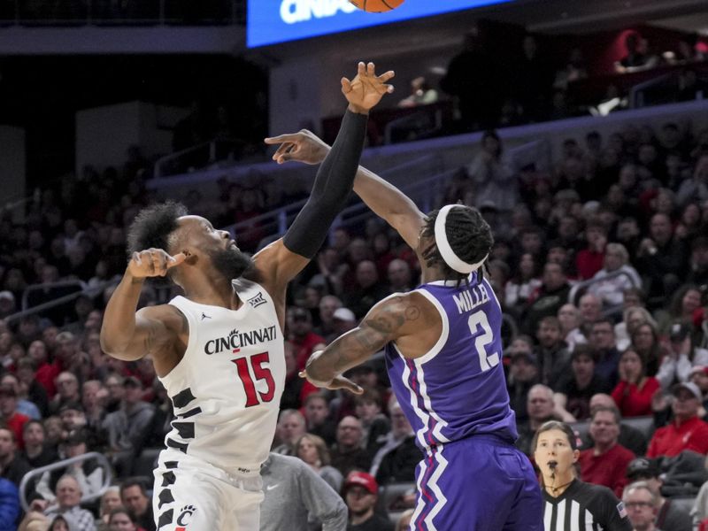 Jan 16, 2024; Cincinnati, Ohio, USA;  Cincinnati Bearcats forward John Newman III (15) reaches for the loose ball against TCU Horned Frogs forward Emanuel Miller (2) in the first half at Fifth Third Arena. Mandatory Credit: Aaron Doster-USA TODAY Sports