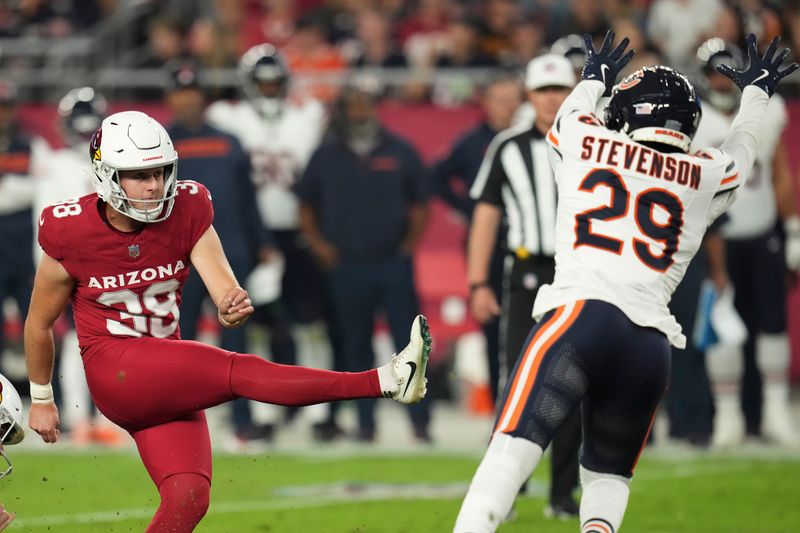 Arizona Cardinals place kicker Chad Ryland (38) kicks a field goal as Chicago Bears cornerback Tyrique Stevenson (29) defends during the second half of an NFL football game Sunday, Nov. 3, 2024, in Glendale, Ariz. (AP Photo/Ross D. Franklin)