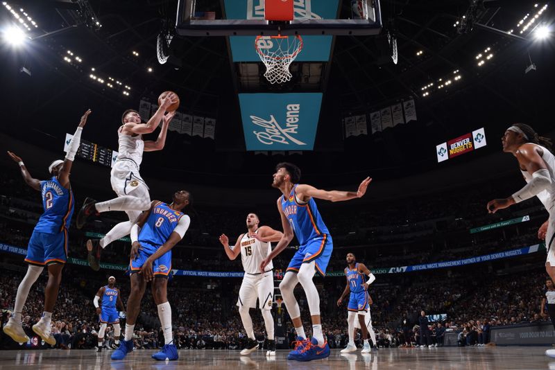 DENVER, CO - OCTOBER 24: Christian Braun #0 of the Denver Nuggets drives to the basket during the game against the Oklahoma City Thunder on October 24, 2024 at Ball Arena in Denver, Colorado. NOTE TO USER: User expressly acknowledges and agrees that, by downloading and/or using this Photograph, user is consenting to the terms and conditions of the Getty Images License Agreement. Mandatory Copyright Notice: Copyright 2024 NBAE (Photo by Garrett Ellwood/NBAE via Getty Images)