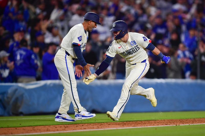 Apr 26, 2025; Los Angeles, California, USA; Los Angeles Dodgers pinch hitter Enrique Hernández (8) is greeted by third base coach/outfield coach Dino Ebel (91) after hitting a three run home run against the Pittsburgh Pirates during the eighth inning at Dodger Stadium. Mandatory Credit: Gary A. Vasquez-Imagn Images