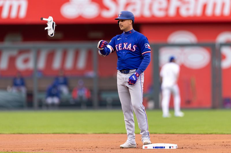 May 4, 2024; Kansas City, Missouri, USA; Texas Rangers first base Nathaniel Lowe (30) tosses his arm guard after hitting a double during the first inning against the Kansas City Royals at Kauffman Stadium. Mandatory Credit: William Purnell-USA TODAY Sports