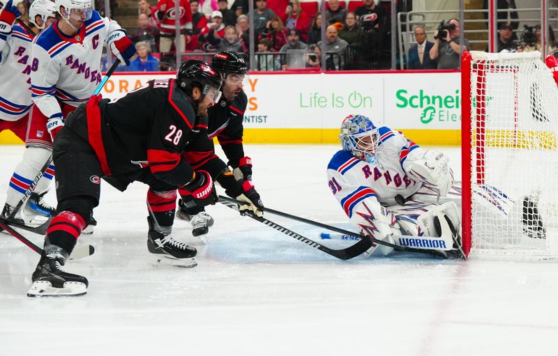 Nov 27, 2024; Raleigh, North Carolina, USA;  New York Rangers goaltender Igor Shesterkin (31) stops the shot attempt by Carolina Hurricanes center William Carrier (28) during the first period at Lenovo Center. Mandatory Credit: James Guillory-Imagn Images