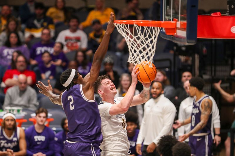 Mar 6, 2024; Morgantown, West Virginia, USA; West Virginia Mountaineers forward Quinn Slazinski (11) shoots against TCU Horned Frogs forward Emanuel Miller (2) during the first half at WVU Coliseum. Mandatory Credit: Ben Queen-USA TODAY Sports