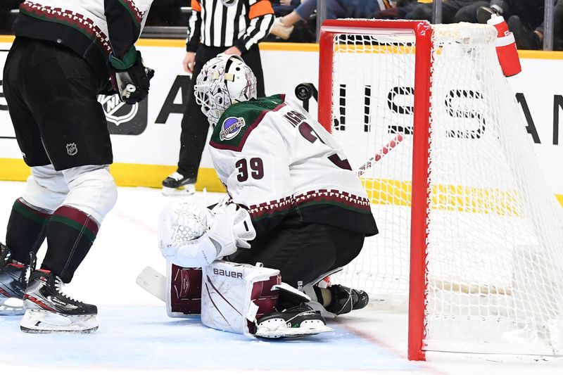 Feb 10, 2024; Nashville, Tennessee, USA; Arizona Coyotes goaltender Connor Ingram (39) has the puck bounce off his back into the net for a goal by Nashville Predators center Ryan O'Reilly (not pictured) during the first period at Bridgestone Arena. Mandatory Credit: Christopher Hanewinckel-USA TODAY Sports