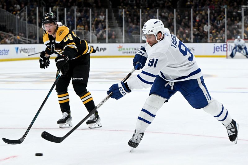 Feb 25, 2025; Boston, Massachusetts, USA; Toronto Maple Leafs center John Tavares (91) attempts a shot in front of Boston Bruins center Morgan Geekie (39) during the second period at the TD Garden. Mandatory Credit: Brian Fluharty-Imagn Images