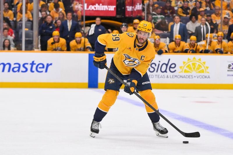 Oct 9, 2025; Nashville, Tennessee, USA; Nashville Predators defenseman Roman Josi (59) skates with the puck against the Columbus Blue Jackets during the second period at Bridgestone Arena. Mandatory Credit: Steve Roberts-Imagn Images