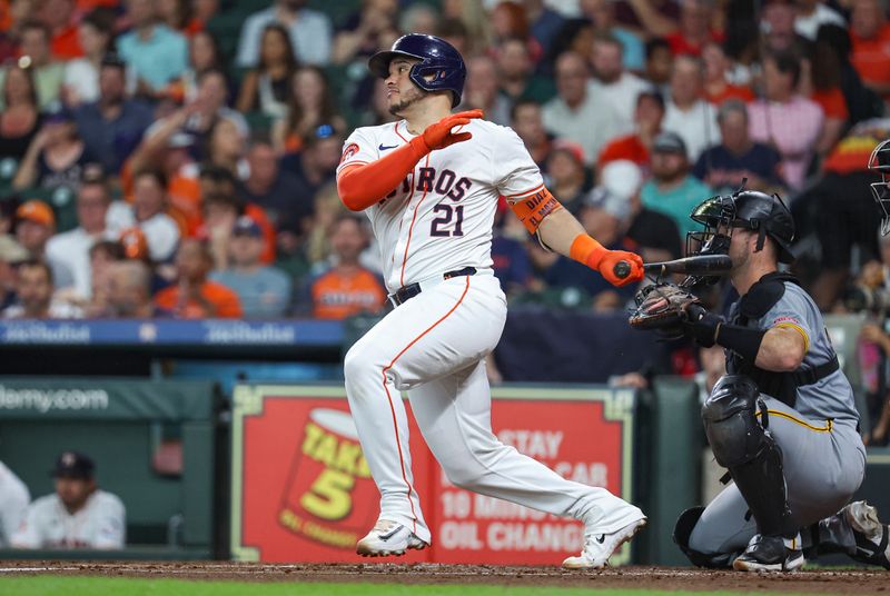 Jul 30, 2024; Houston, Texas, USA; Houston Astros catcher Yainer Diaz (21) hits a single during the second inning against the Pittsburgh Pirates at Minute Maid Park. Mandatory Credit: Troy Taormina-USA TODAY Sports