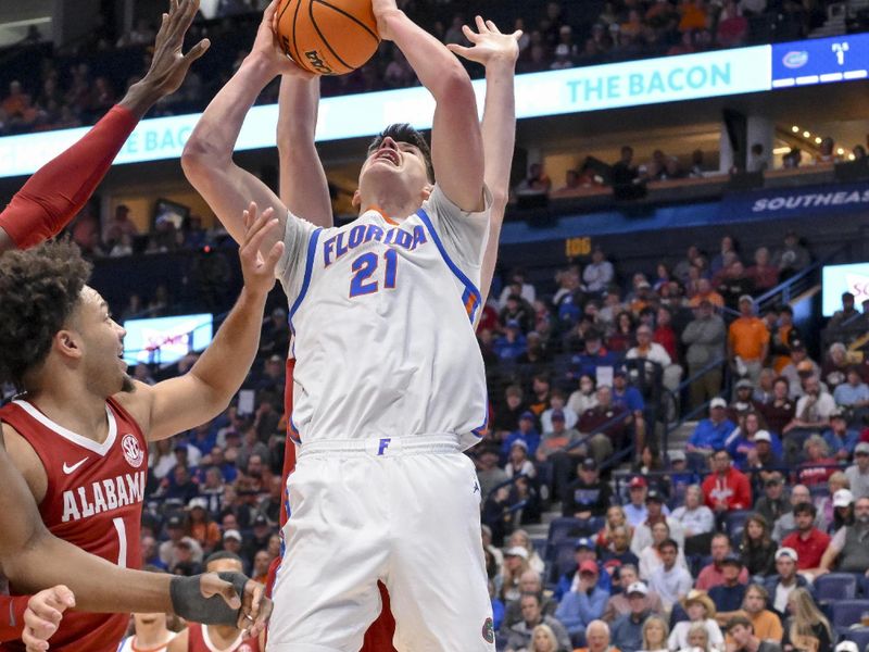 Mar 15, 2025; Nashville, TN, USA;  Alabama Crimson Tide forward Grant Nelson (4) blocks the shot of  Florida Gators forward Alex Condon (21) during the first half at Bridgestone Arena. Mandatory Credit: Steve Roberts-Imagn Images