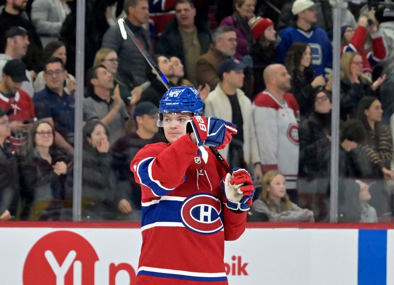 Jan 6, 2025; Montreal, Quebec, CAN; Montreal Canadiens forward Cole Caufield (13) points to the exit for Vancouver Canucks goalie Kevin Lankinen (not pictured) who stayed in his net after the winning goal by Montreal Canadiens forward Nick Suzuki (not pictured) during the overtime period at the Bell Centre. Mandatory Credit: Eric Bolte-Imagn Images