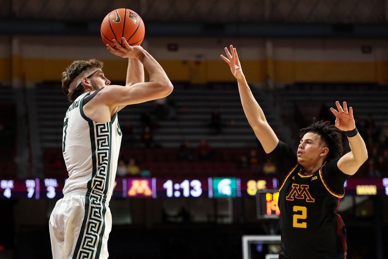 Dec 4, 2024; Minneapolis, Minnesota, USA; Michigan State Spartans guard Gehrig Normand (7) shoots as Minnesota Golden Gophers guard Mike Mitchell Jr. (2) defends during the second half at Williams Arena. Mandatory Credit: Matt Krohn-Imagn Images