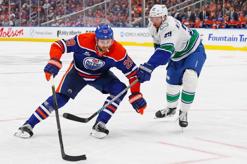 Oct 11, 2025; Edmonton, Alberta, CAN; Edmonton Oilers forward Leon Draisaitl (29) caries the puck around Vancouver Canucks defensemen Marcus Pettersson (29) during the third period at Rogers Place. Mandatory Credit: Perry Nelson-Imagn Images