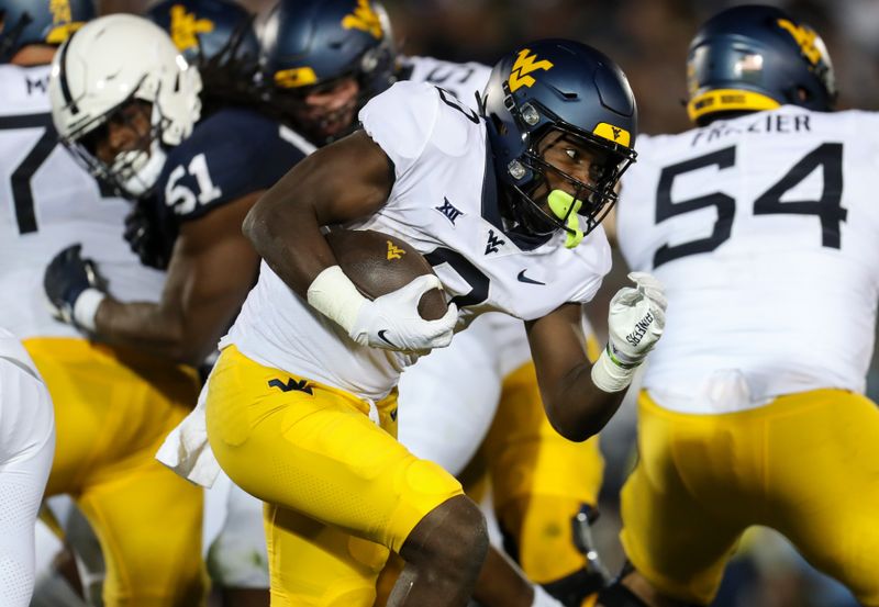 Sep 2, 2023; University Park, Pennsylvania, USA; West Virginia Mountaineers running back Jaylen Anderson (0) runs the ball against the Penn State Nittany Lions during the fourth quarter at Beaver Stadium. Penn State won 38-15. Mandatory Credit: Matthew O'Haren-USA TODAY Sports