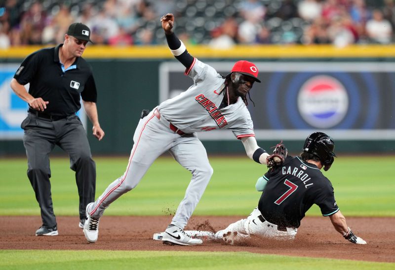 May 13, 2024; Phoenix, Arizona, USA; Cincinnati Reds shortstop Elly De La Cruz (44) tags out Arizona Diamondbacks outfielder Corbin Carroll (7) during a steal attempt during the fourth inning at Chase Field. Mandatory Credit: Joe Camporeale-USA TODAY Sports