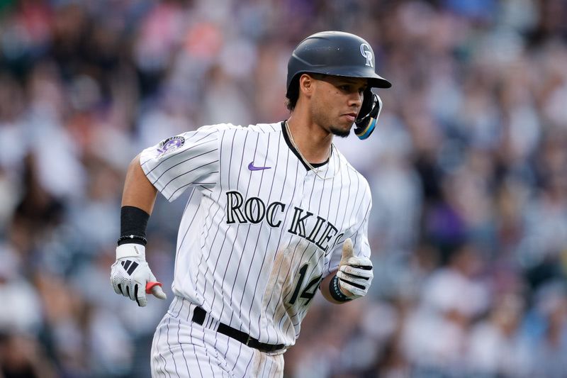 Jun 30, 2023; Denver, Colorado, USA; Colorado Rockies shortstop Ezequiel Tovar (14) rounds the bases on a three run home run in the sixth inning against the Detroit Tigers at Coors Field. Mandatory Credit: Isaiah J. Downing-USA TODAY Sports
