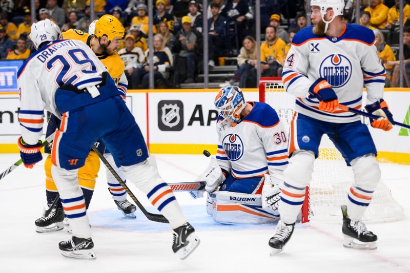 Oct 31, 2024; Nashville, Tennessee, USA;  Edmonton Oilers goaltender Calvin Pickard (30) blocks the shot of Nashville Predators center Tommy Novak (82) during the first period at Bridgestone Arena. Mandatory Credit: Steve Roberts-Imagn Images