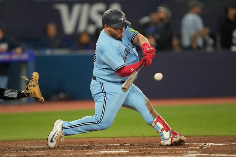 Sep 28, 2023; Toronto, Ontario, CAN; Toronto Blue Jays catcher Alejandro Kirk (30) singles against the New York Yankees during the fifth inning at Rogers Centre. Mandatory Credit: John E. Sokolowski-USA TODAY Sports