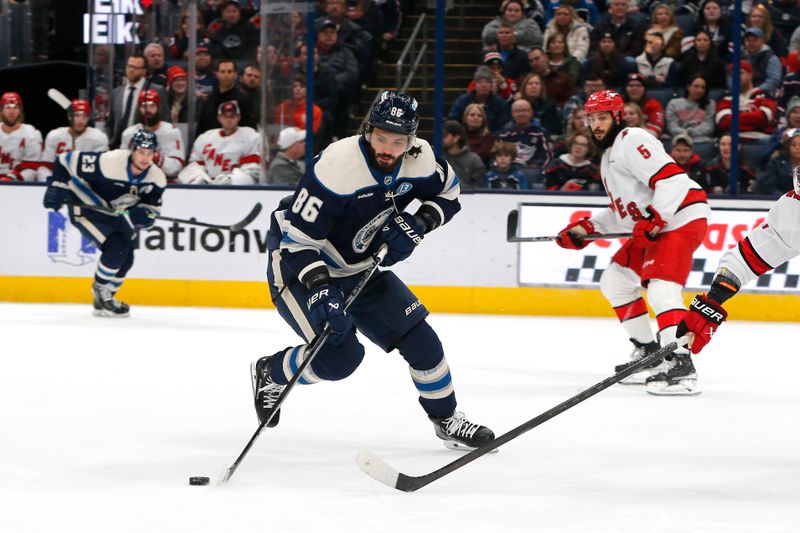 Dec 31, 2024; Columbus, Ohio, USA; Columbus Blue Jackets right wing Kirill Marchenko (86) carries the puck against the Carolina Hurricanes during the first period at Nationwide Arena. Mandatory Credit: Russell LaBounty-Imagn Images