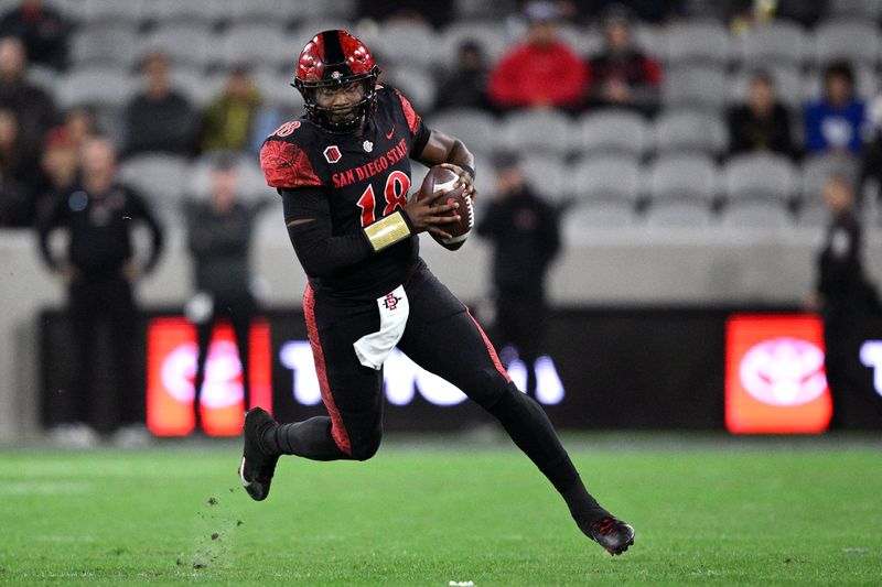 Nov 25, 2023; San Diego, California, USA; San Diego State Aztecs quarterback Jalen Mayden (18) runs the ball during the first half against the Fresno State Bulldogs at Snapdragon Stadium. Mandatory Credit: Orlando Ramirez-USA TODAY Sports