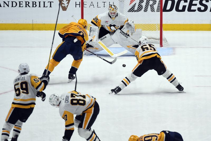 Nov 28, 2023; Nashville, Tennessee, USA; Nashville Predators left wing Filip Forsberg (9) scores the game-winning goal against Pittsburgh Penguins goaltender Tristan Jarry (35) in overtime at Bridgestone Arena. Mandatory Credit: Christopher Hanewinckel-USA TODAY Sports