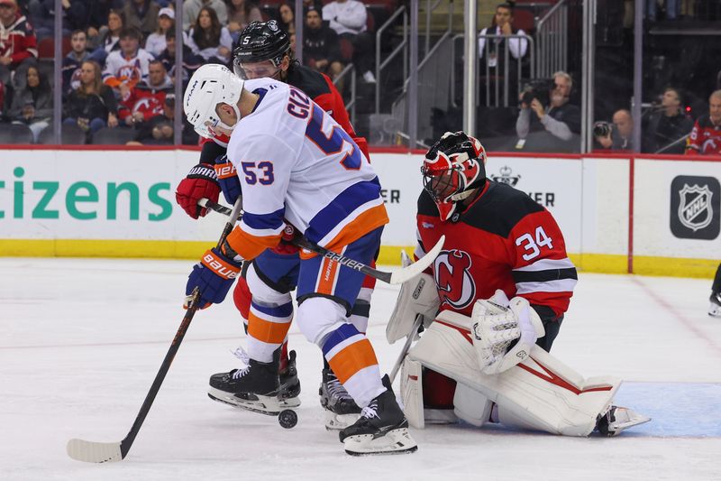 Oct 25, 2024; Newark, New Jersey, USA; New Jersey Devils goaltender Jake Allen (34) makes a save against the New York Islanders during the third period at Prudential Center. Mandatory Credit: Ed Mulholland-Imagn Images