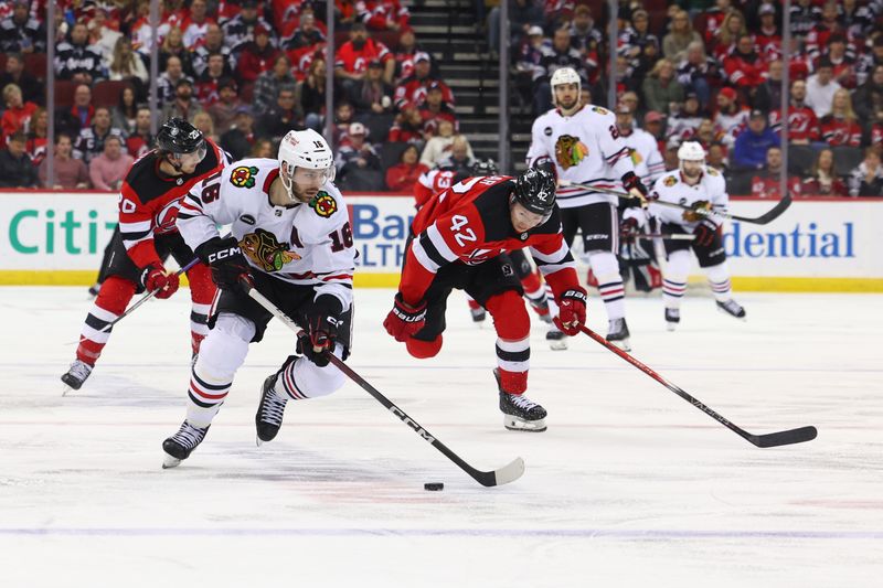 Jan 5, 2024; Newark, New Jersey, USA; Chicago Blackhawks center Jason Dickinson (16) skates with the puck against the New Jersey Devils during the third period at Prudential Center. Mandatory Credit: Ed Mulholland-USA TODAY Sports